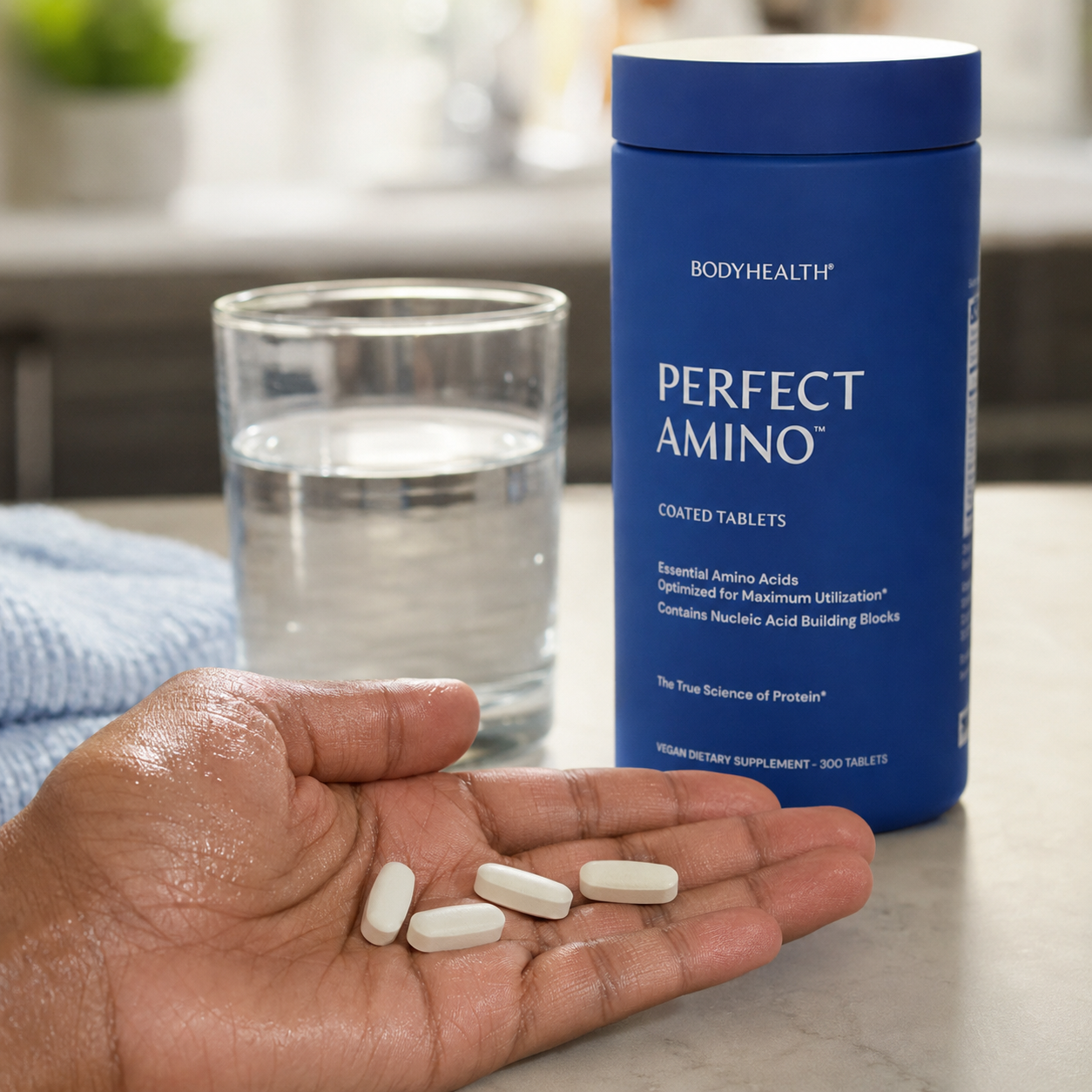 Five PerfectAmino tablets in hand beside the product and water